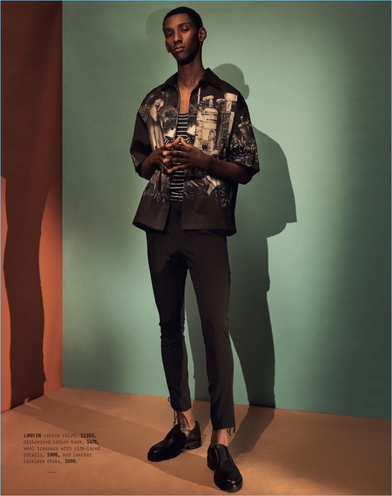 Myles Dominique wears a Lanvin graphic oversized shirt $689, laced-side wool trousers $599, and leather laceless bluchers $690.