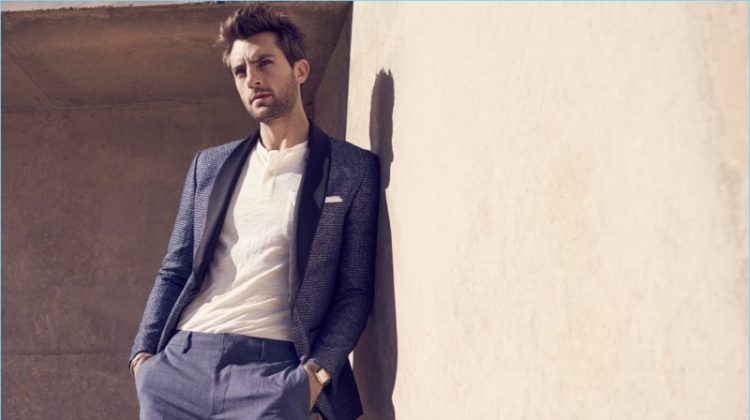 A sharp vision, Rafael Lazzini wears a dapper blue suit with a henley top.