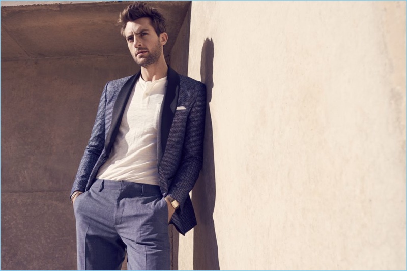 A sharp vision, Rafael Lazzini wears a dapper blue suit with a henley top.