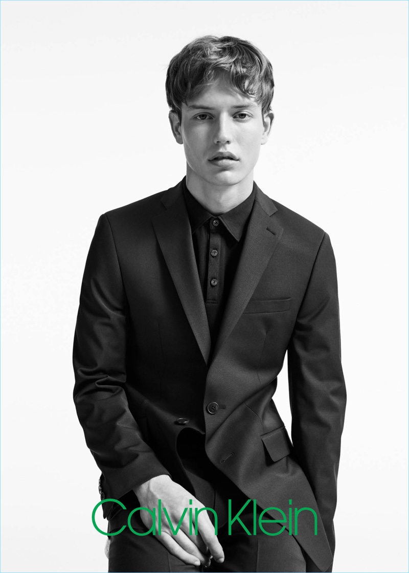 Donning a black single-breasted suit with a polo, Nathan Morgan stars in Calvin Klein's spring-summer 2017 campaign.
