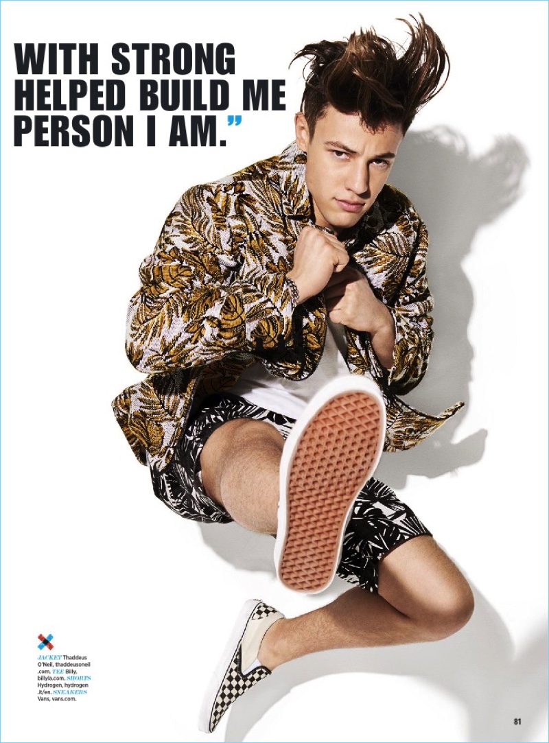 Leaping into action, Cameron Dallas dons a Thaddeus O'Neil jacket with a Billy tee, Hydrogen shorts, and Vans sneakers.