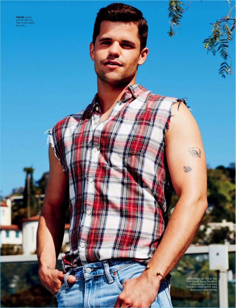 Actor Charlie Carver wears a New Look cut-off shirt with Levi's denim jeans.