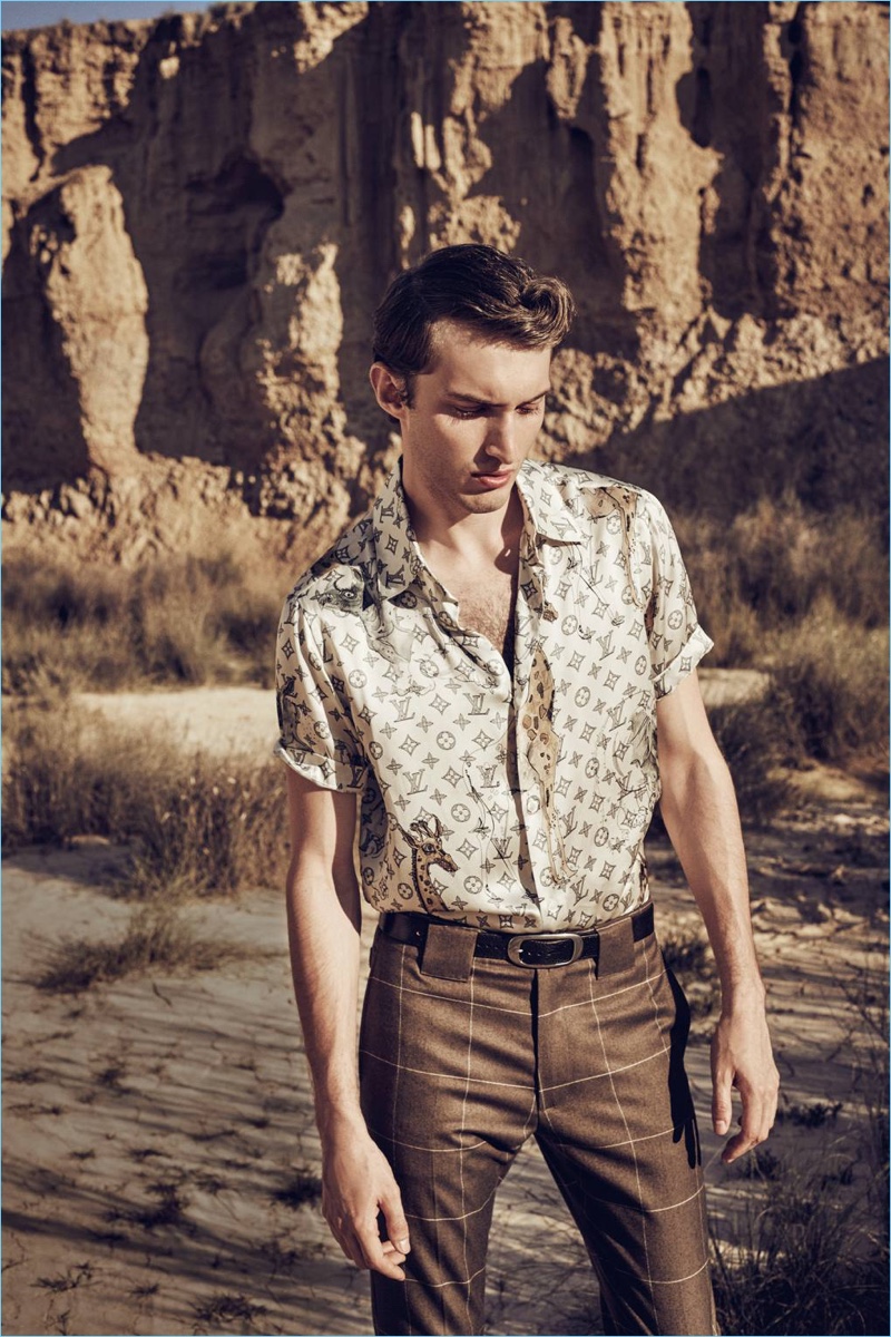 Dashing in chic styles from Louis Vuitton, Charlie France wears a silk monogram print shirt and windowpane print trousers. Charlie also sports a Lanvin leather belt.