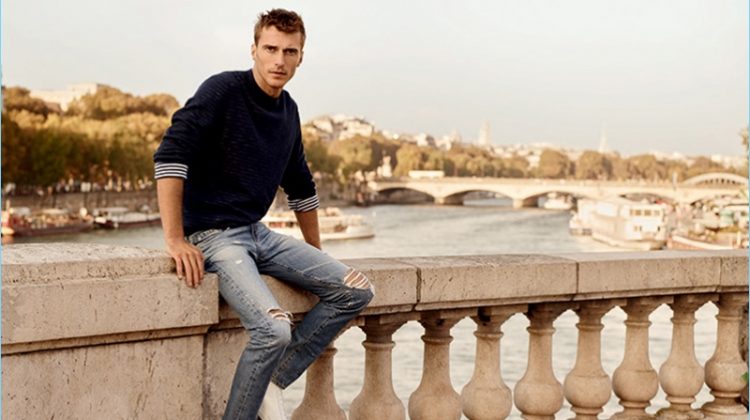 French model Clément Chabernaud wears skinny jeans, ripped at the knees, for AG Jeans' spring-summer 2017 campaign.