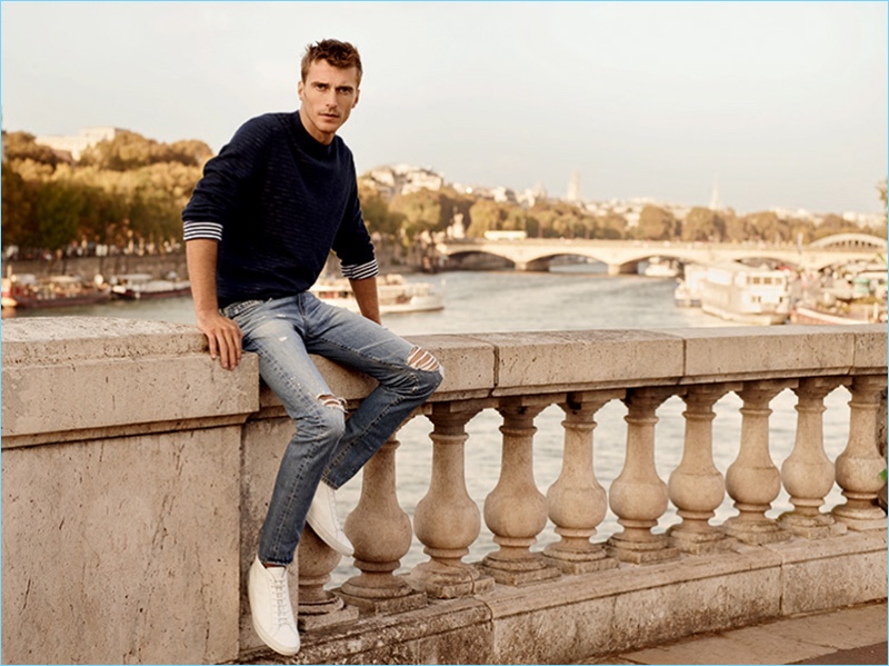 French model Clément Chabernaud wears skinny jeans, ripped at the knees, for AG Jeans' spring-summer 2017 campaign.