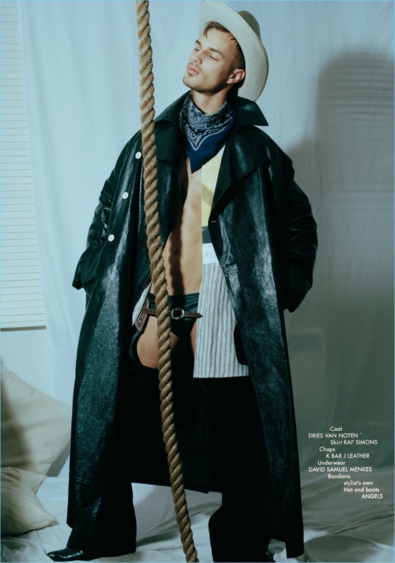 Front and center, Denek Kania wears a Dries Van Noten coat, Raf Simons shirt, and K Bar J Leather chaps. He also rocks David Samuel Menkes underwear with a hat and boots by Angels.