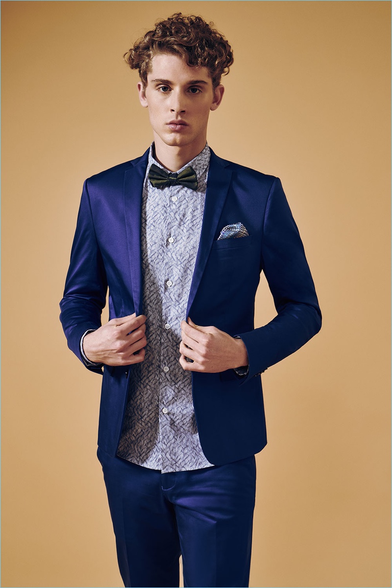 Valerio dons a trim blue suit with a patterned shirt from David Naman.