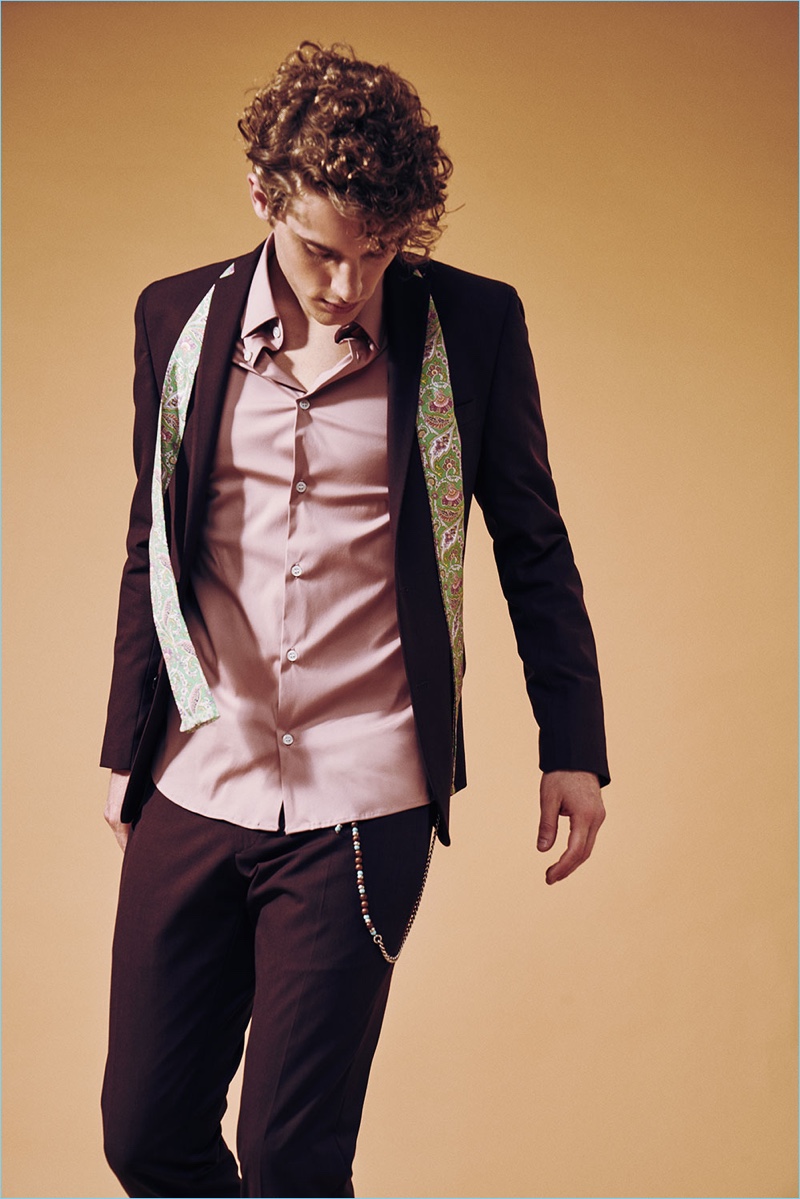 Emanuele Menduni photographs Valerio in a burgundy suit with a pastel shirt and paisley scarf from David Naman.