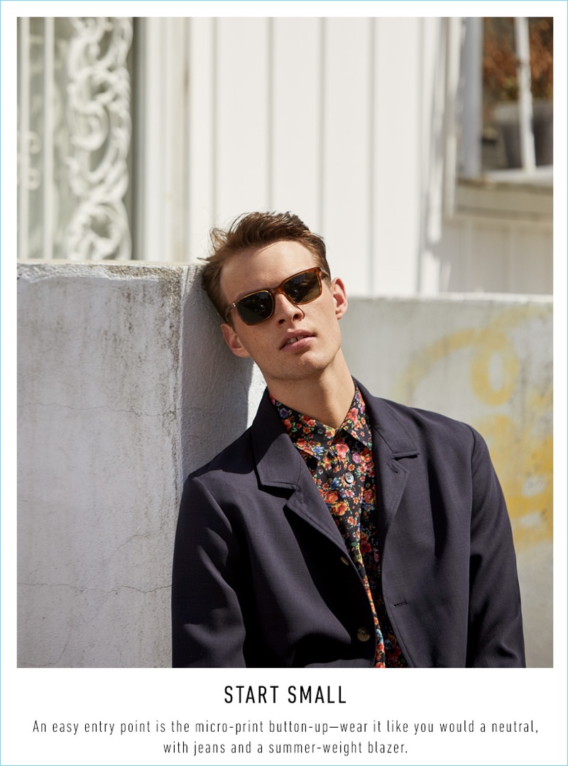 Rocky Harwood wears an Our Legacy flower print shirt $319, Editions M.R. blouson jacket $285, and Oliver Peoples sunglasses $430.
