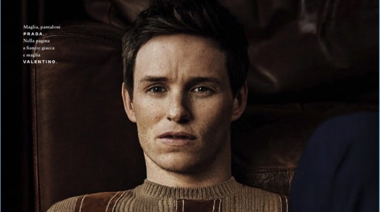 Front and center, Eddie Redmayne sports a sweater and trousers by Prada.