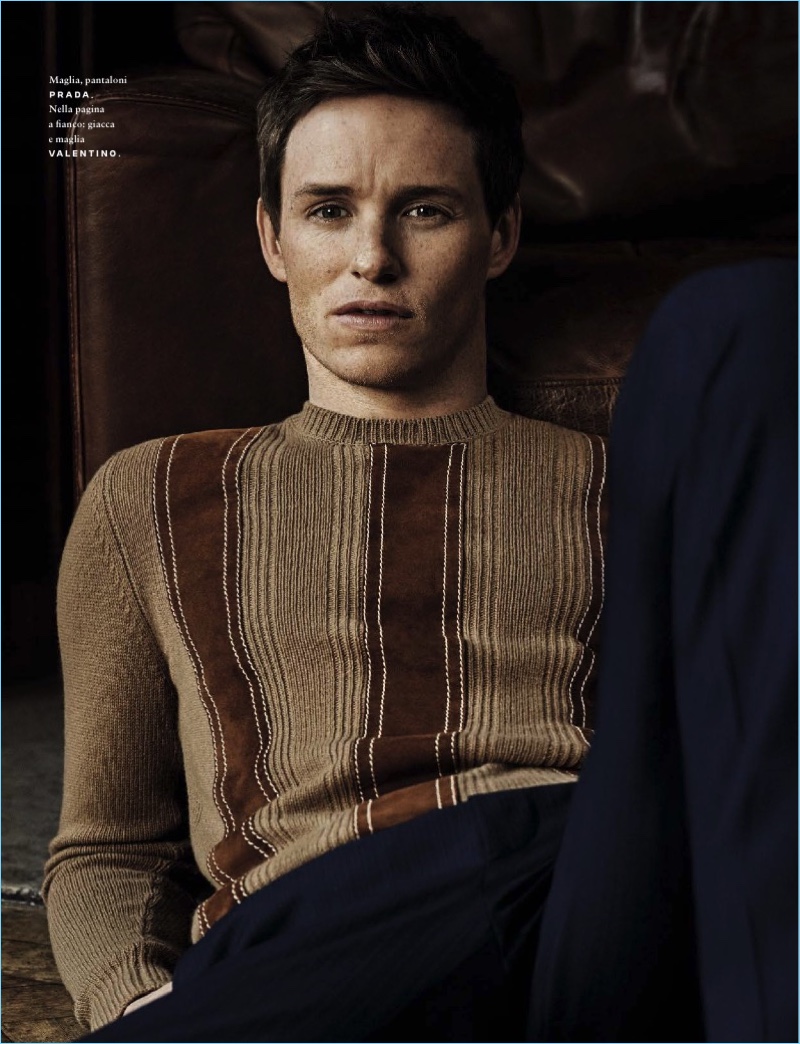 Front and center, Eddie Redmayne sports a sweater and trousers by Prada.