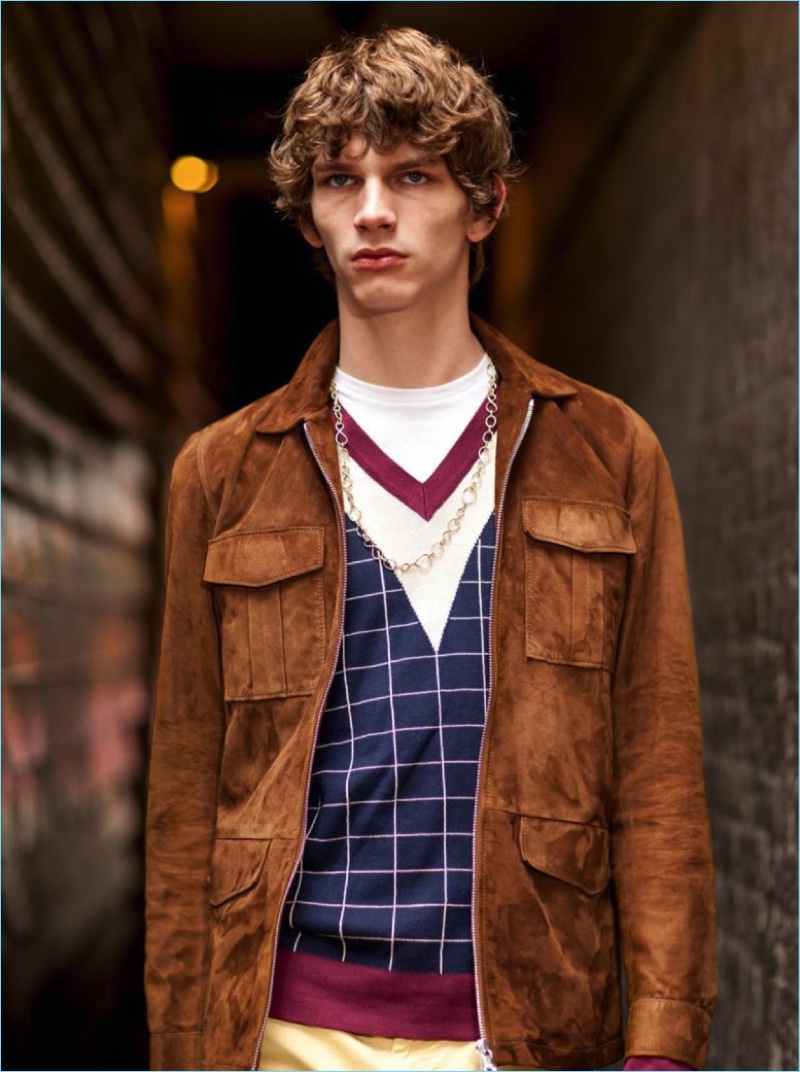 Erik van Gils wears a brown suede jacket by Officine Generale with a Rossignol sweater, and American Vintage t-shit. The model also sports Balibaris pants, and a David Yurman chain necklace.