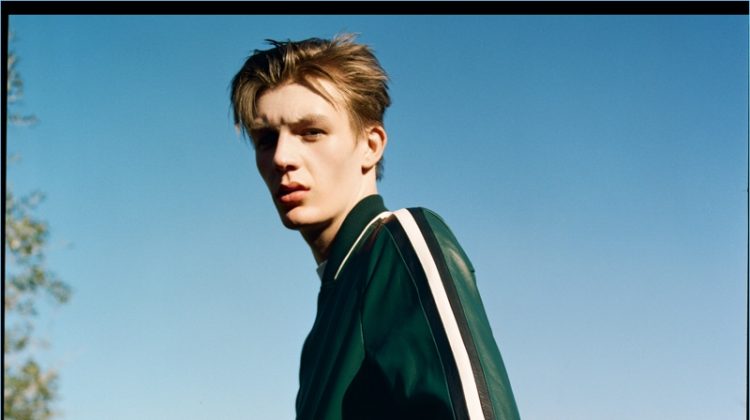 Finnlay Davis wears a green leather track suit by Bally.