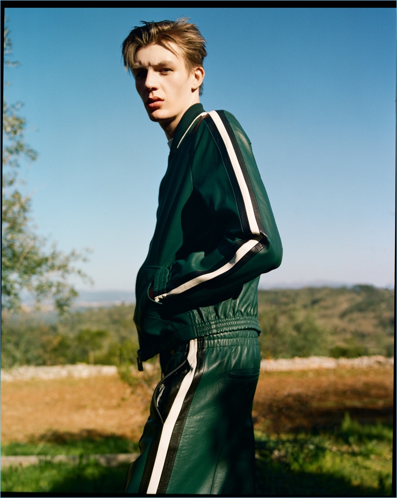 Finnlay Davis wears a green leather track suit by Bally.