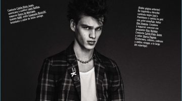 Front and center, Filip Hrivnak wears a Calvin Klein Jeans shirt with a plaid Louis Vuitton blazer, and GUESS by Marciano jeans.
