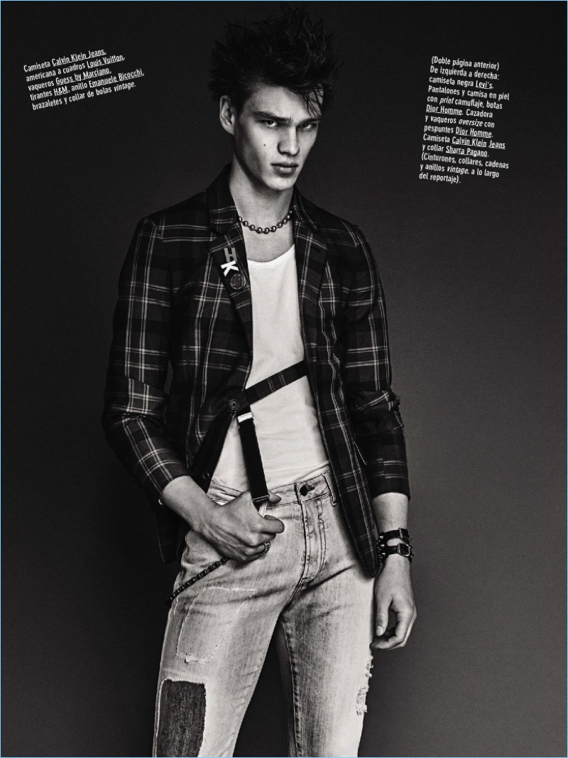 Front and center, Filip Hrivnak wears a Calvin Klein Jeans shirt with a plaid Louis Vuitton blazer, and GUESS by Marciano jeans.