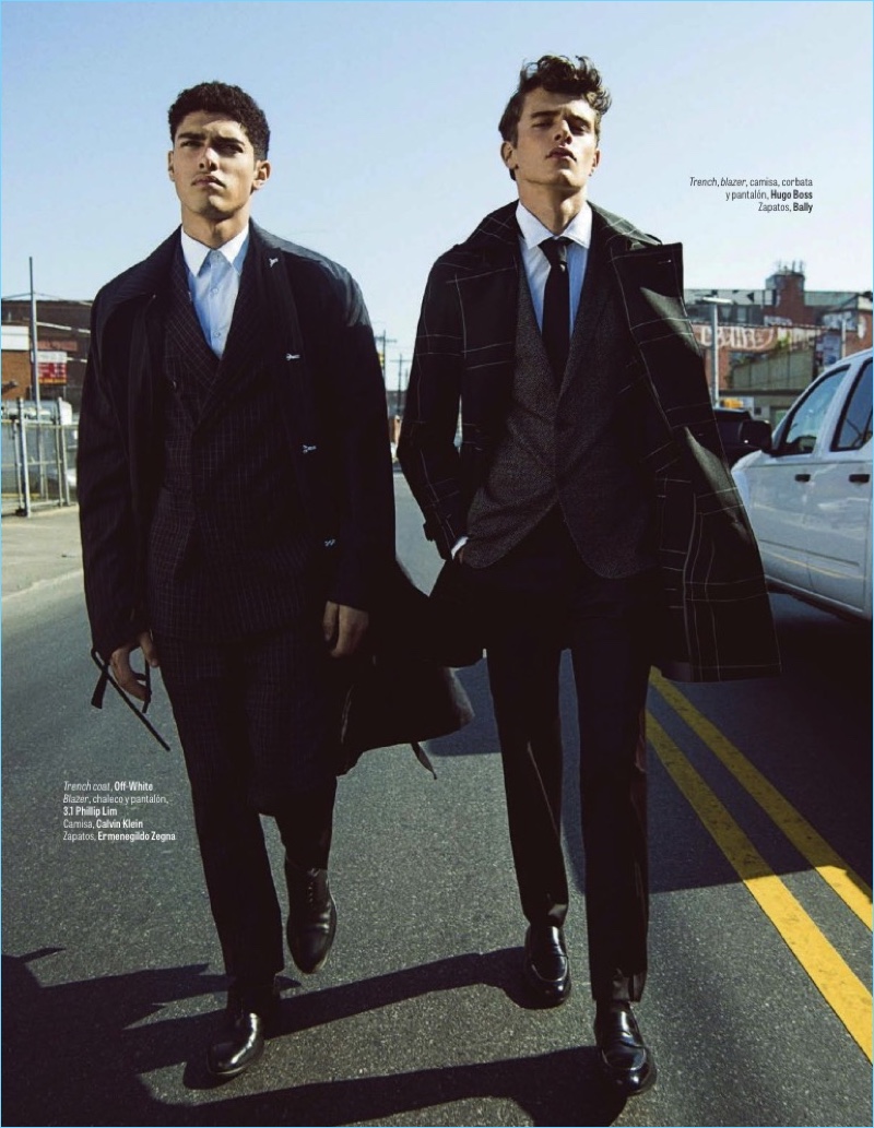 Left to Right: Torin Verdone models an Off-White trench coat with a 3.1 Phillip Lim suit, Calvin Klein shirt, and Ermenegildo Zegna shoes. Jordy Baan sports a Hugo Boss look with Bally shoes.