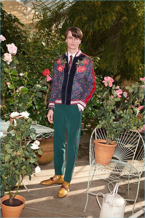 Modern dandy style reigns with a Gucci heart embroidered shirt $640 and velvet and paisley print bomber jacket $3,350. The outfit comes together with Gucci trousers $1,150, leather Chelsea boots $980, and a tie $200.