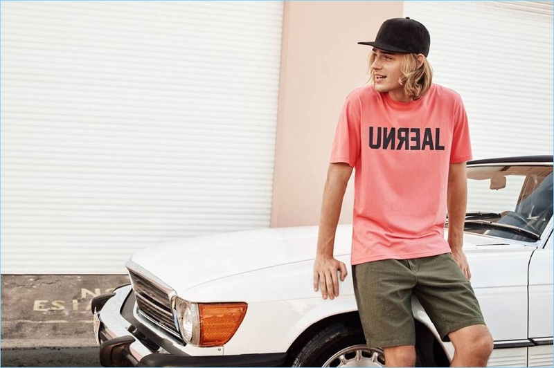 Tapping into laid-back style, Ton Heukels wears a H&M Unreal print t-shirt $12.99, linen-blend knee-length shorts $29.99, and a imitation suede cap $12.99.