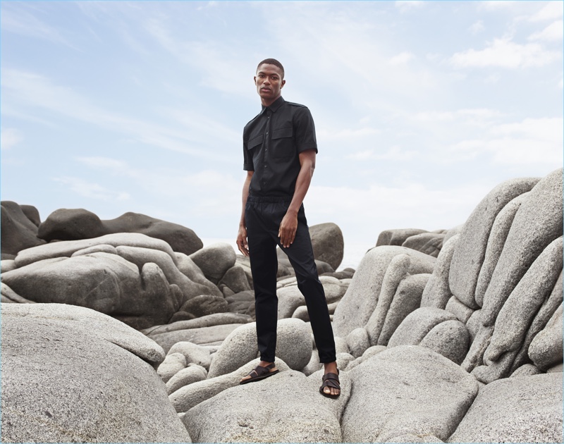 Hamid Onifade wears a short-sleeve utility shirt $24.99, elasticated pants, and leather sandals $24.99 for H&M's summer 2017 campaign.