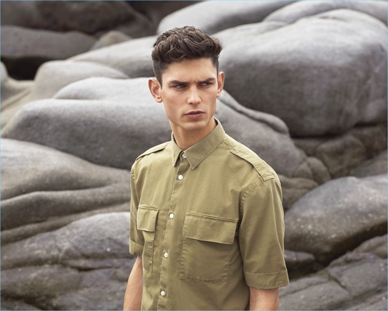 Arthur Gosse sports a khaki-beige short-sleeved utility shirt $24.99 for H&M's summer 2017 campaign.