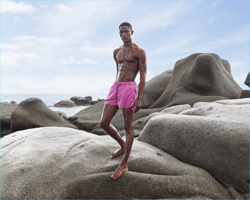 Starring in H&M's summer 2017 campaign, Hamid Onifade sports pink swim shorts.