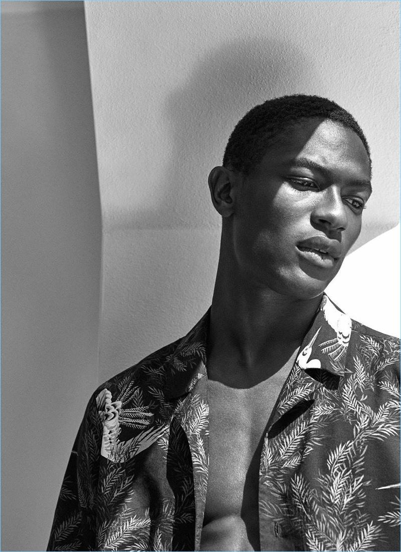 Appearing in a black and white photo, Hamid Onifade sports a resort shirt $24.99 with a birds pattern.