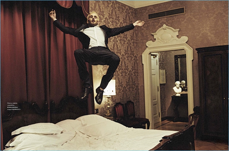 Sporting a classic Fendi suit, Hopper Penn jumps in bed.
