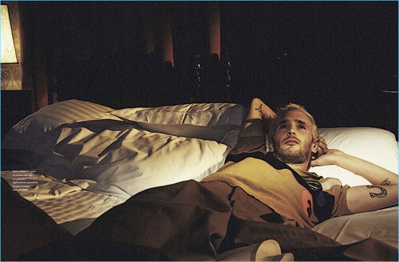 Relaxing in bed, Hopper Penn wears a Fendi look for GQ Italia.
