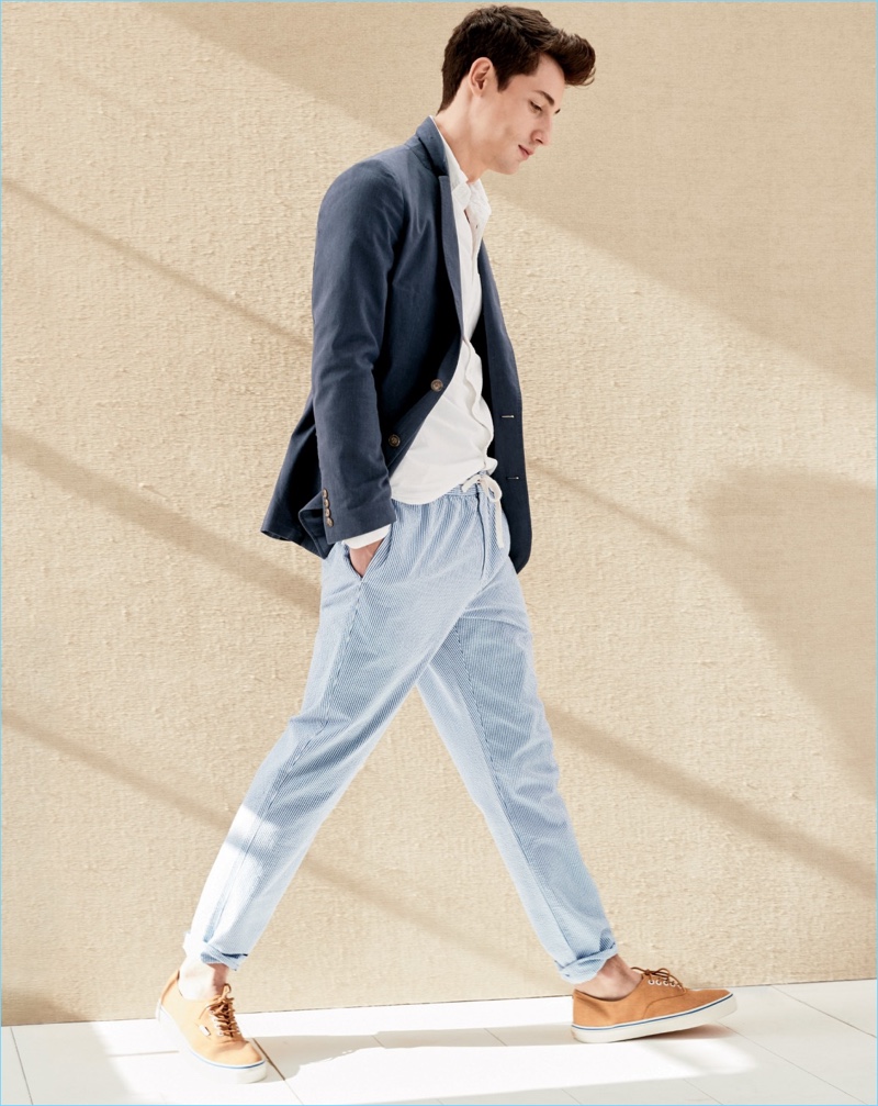 Nicolas Ripoll dons J.Crew drawstring pants in seersucker with a navy sport coat. He also wears a white oxford shirt and sneakers.