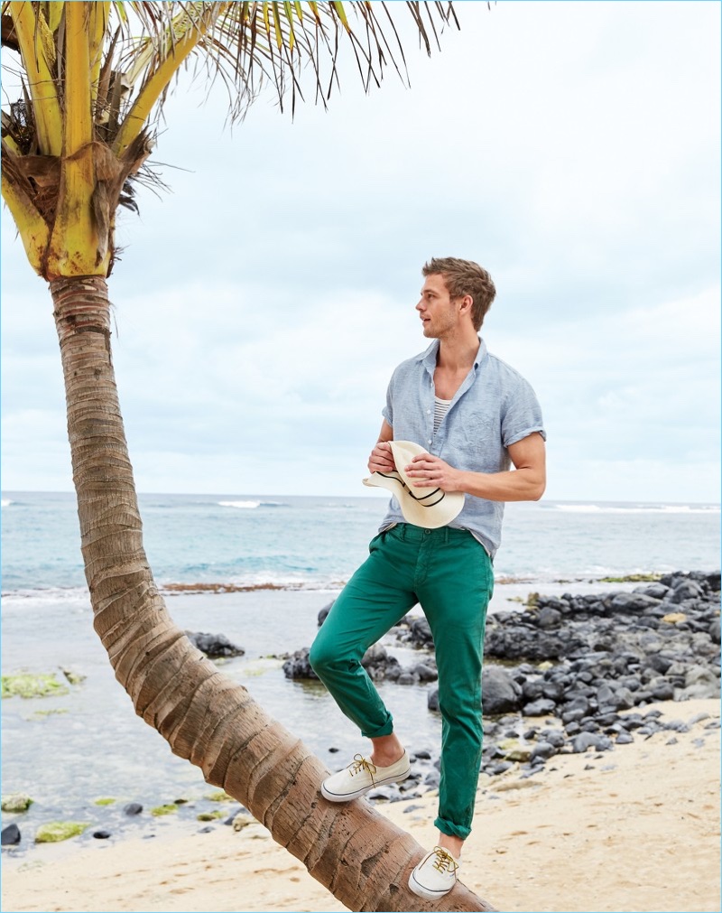 Ready for summer, Benjamin Eidem sports a J.Crew short-sleeve linen shirt $69.50 and striped tank $39.50. The French model also wears J.Crew garment-dyed chinos $70, a panama hat $65, and Vans $60.