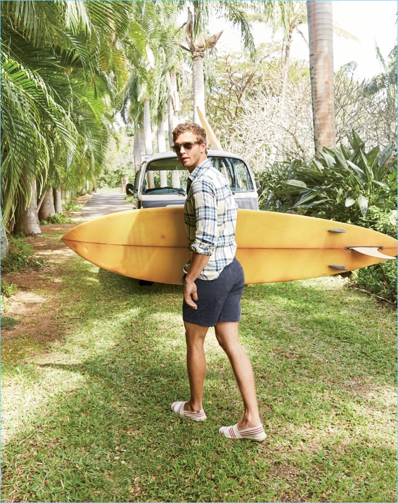 Tackling vacation style, Benjamin Eidem wears a J.Crew plaid shirt $69.50, dock shorts $65, sunglasses $118, and Soludos espadrilles $52.