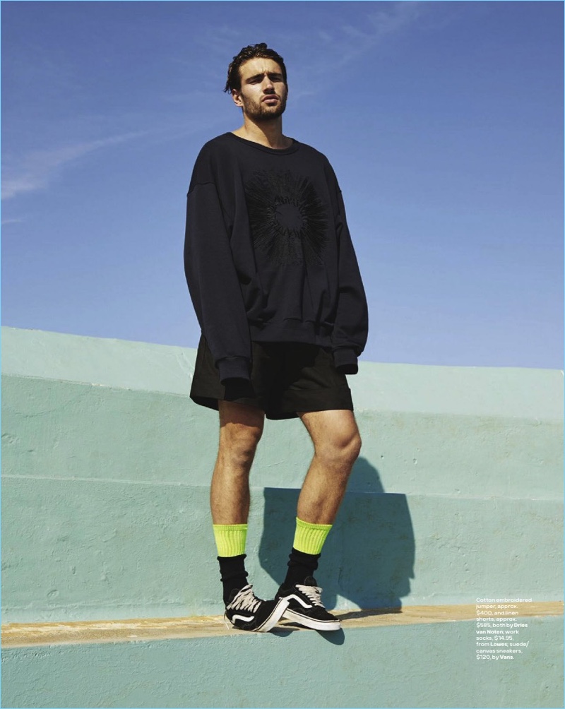 Embracing the oversized trend, Jack Tyerman wears a sweater and shorts from Dries Van Noten. Jack also sports Loewe socks and Vans sneakers.