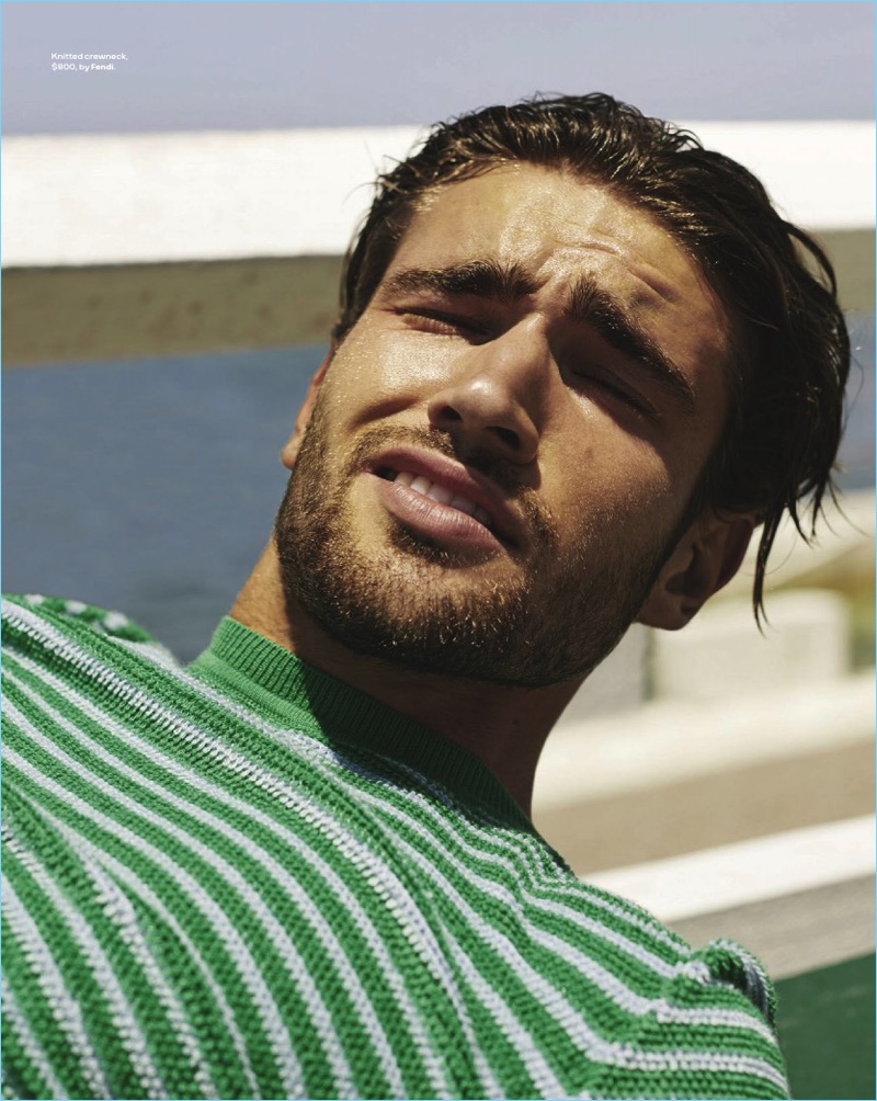 Ready for his close-up, Jack Tyerman sports a green and white striped Fendi sweater.
