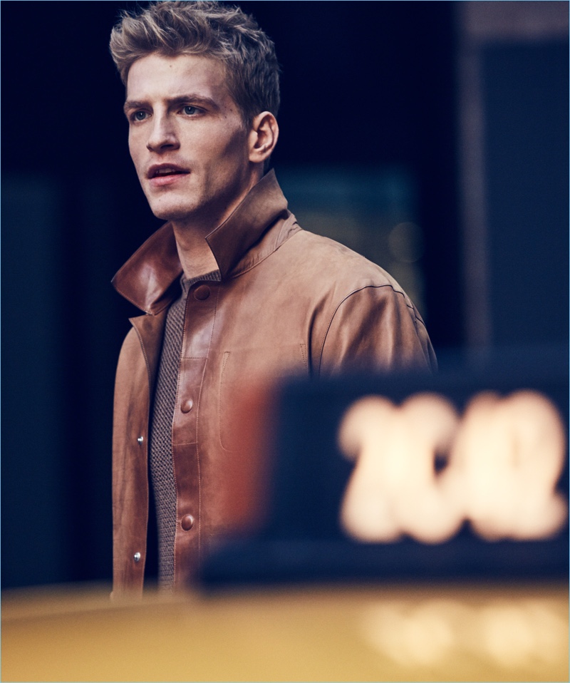 Front and center, Jesse Shannon sports an Ermenegildo Zegna leather jacket and cashmere sweater.