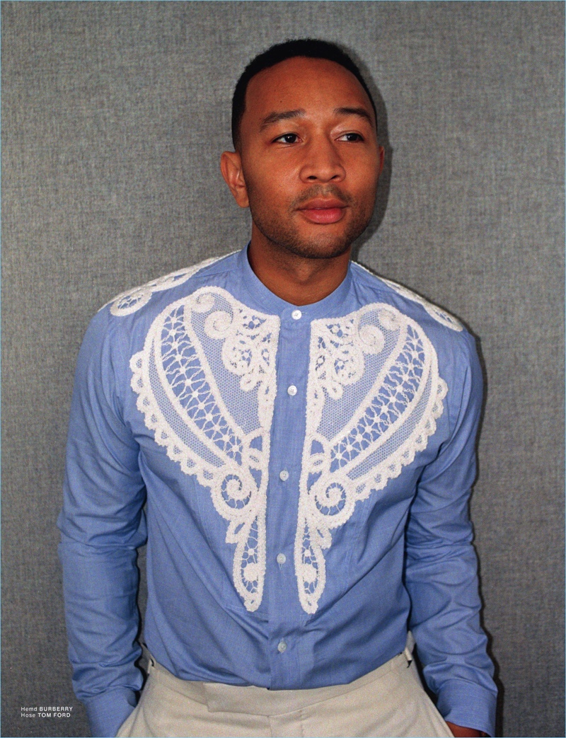 Making a bold fashion statement, John Legend wears a lace adorned Burberry shirt with Tom Ford trousers.
