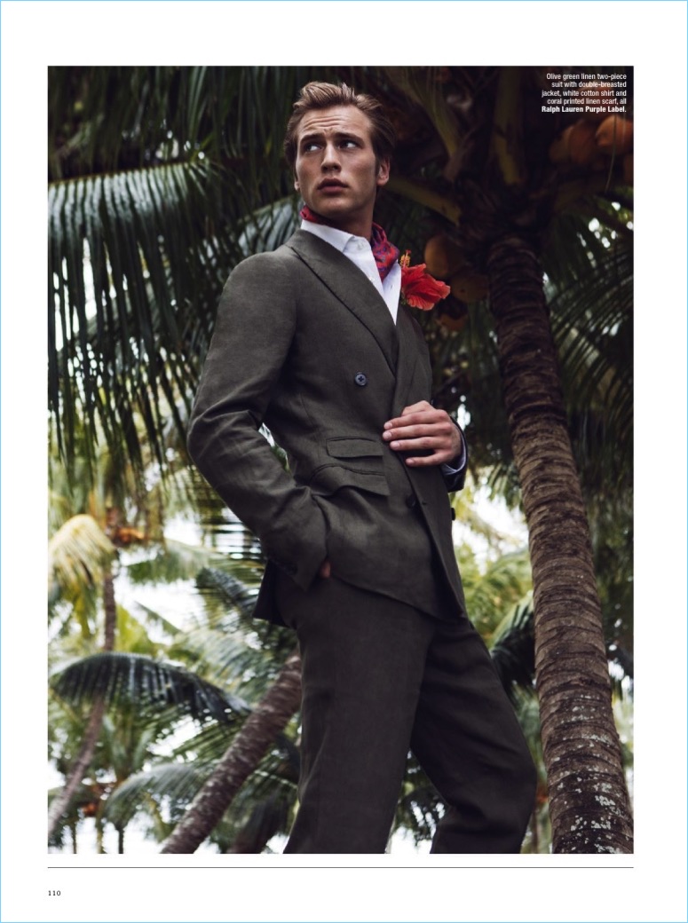 Jules Raynal wears an olive green linen suit with a shirt and printed linen scarf by Ralph Lauren Purple Label.