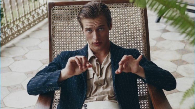 Model Jules Raynal sports a Caruso jacket with a Moncler shirt and Salvatore Ferragamo trousers.