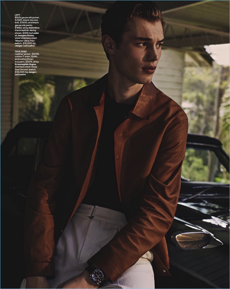 Kit Butler wears a brown leather jacket, t-shirt, and linen trousers by Ermenegildo Zegna. The British model also sports a Jaeger-LeCoultre watch.