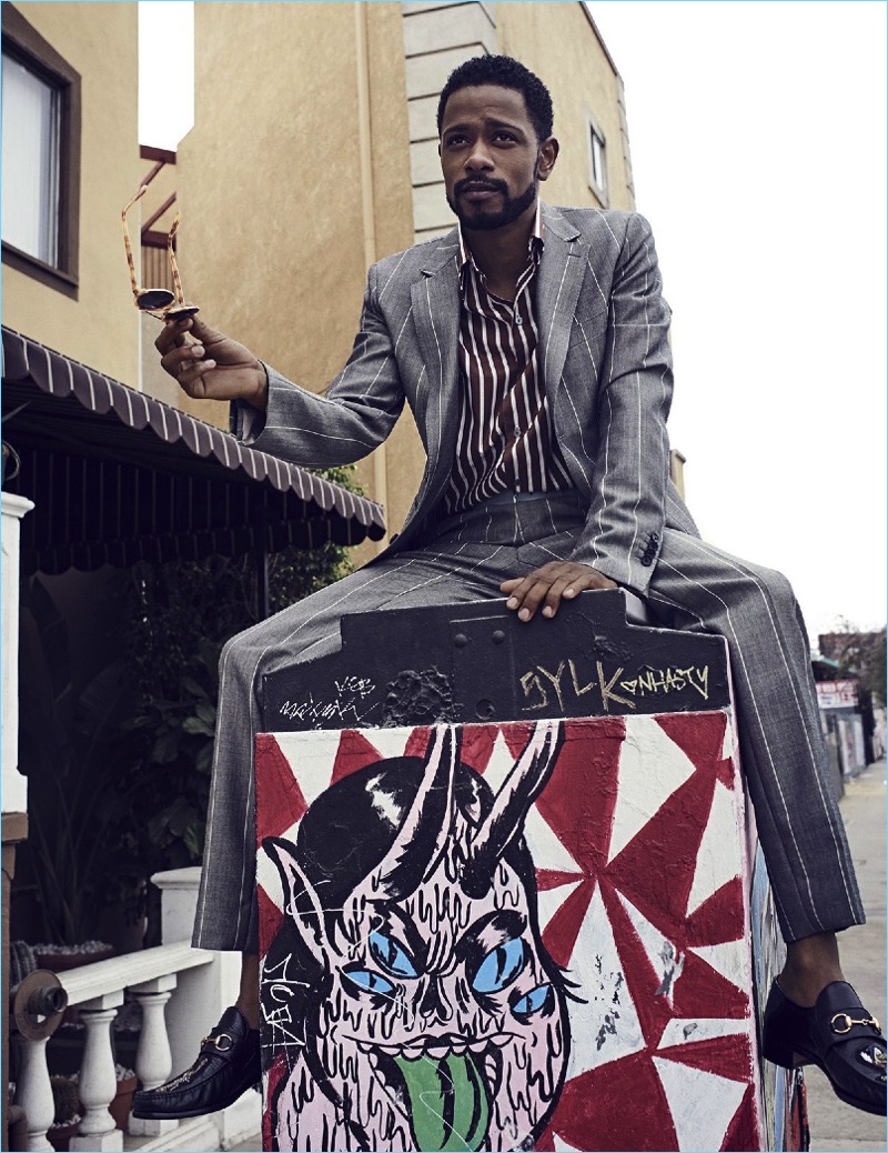 Atlanta star Lakeith Stanfield dons a Salvatore Ferragamo suit with a striped Lanvin shirt and Gucci loafers.