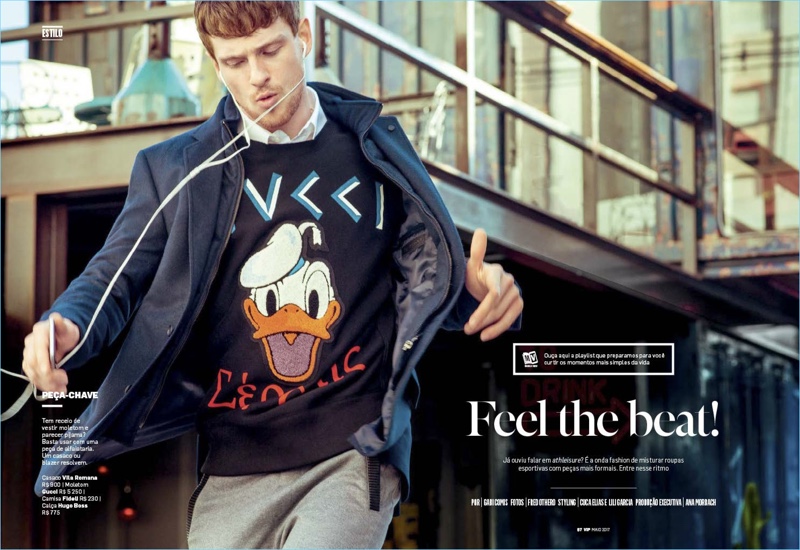 Lucas Mascarini wears a Vila Romana coat with a Gucci Donald Duck sweatshirt, Fidell shirt, and Hugo Boss pants.