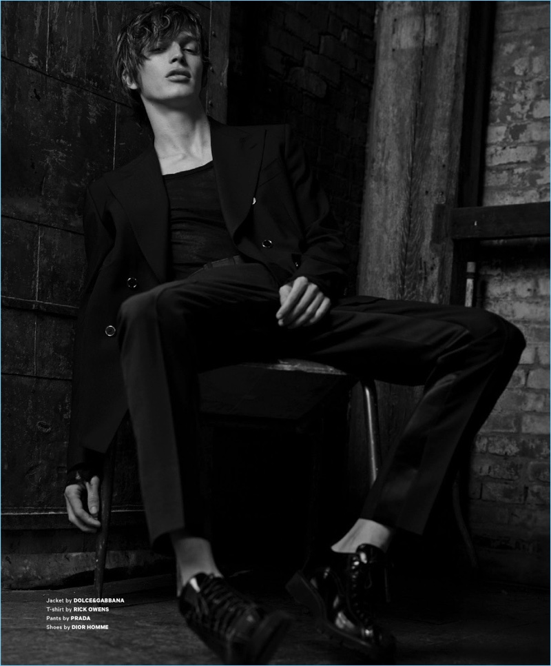 Appearing in an editorial for Essential Homme, Lucas Satherley wears a Dolce & Gabbana jacket with a Rick Owens t-shirt, Prada trousers, and Dior Homme shoes.