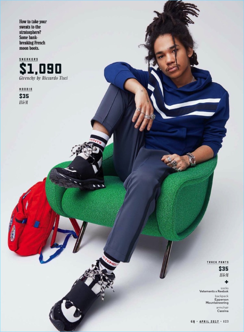 Model Luka Sabbat sports a H&M hoodie with H&M track pants, Givenchy sneakers, and Vetements x Reebok socks.