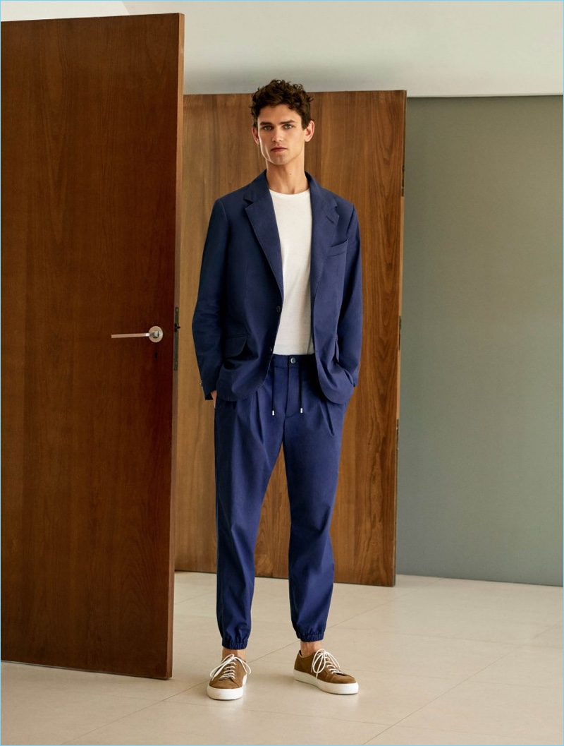 Front and center, Arthur Gosse wears a Mango Man unstructured suit blazer $199.99 and trousers $69.99. The French model also dons a Mango Man essential cotton-blend t-shirt $15.99 and lace-up suede sneakers $99.99.