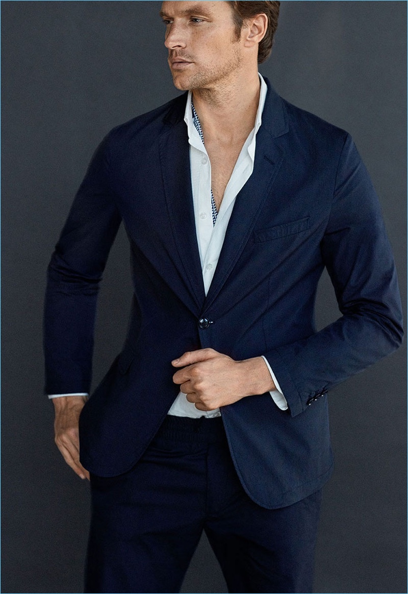 Shaun DeWet dons a navy cotton suit with a slim-fit blazer by Massimo Dutti.