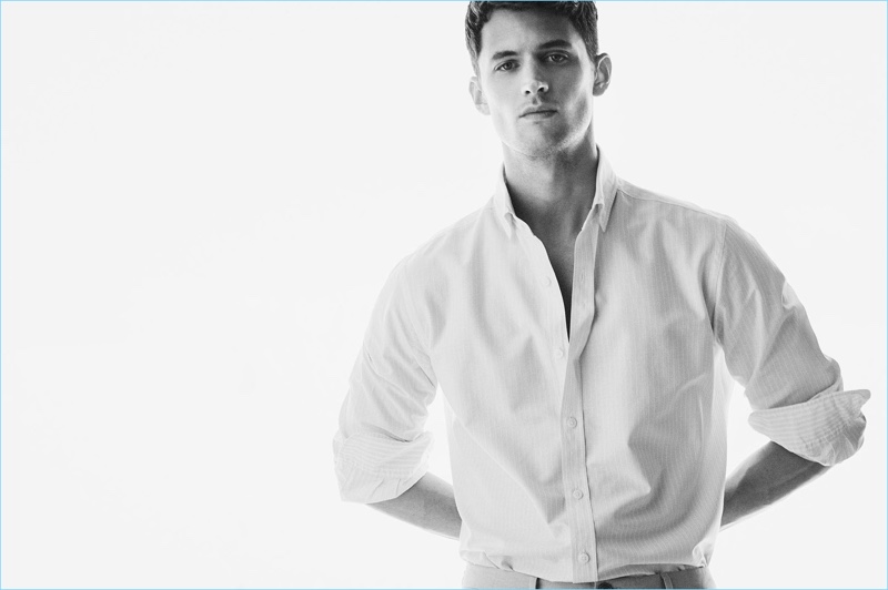 Standing strong, Garrett Neff dons a classic shirt by Massimo Dutti.