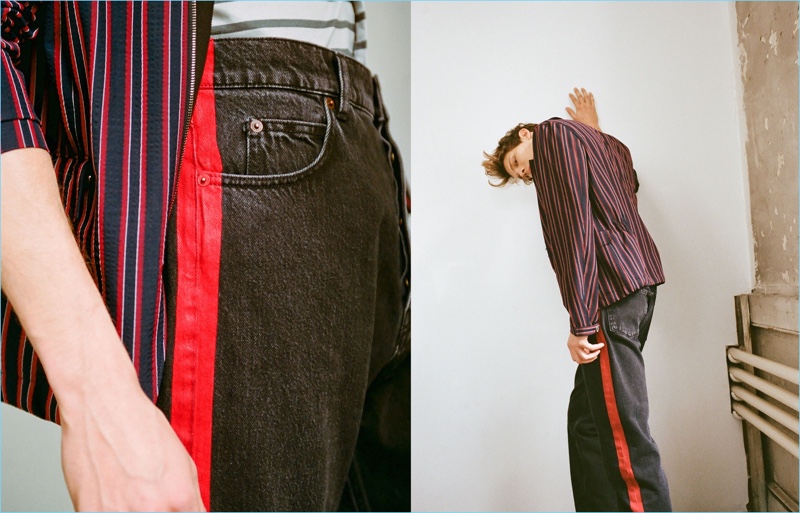 Model Felix Gesnouin wears a Wooyoungmi point-collar striped blazer $662, Lanvin striped t-shirt $475, and Balenciaga side-striped jeans $485.
