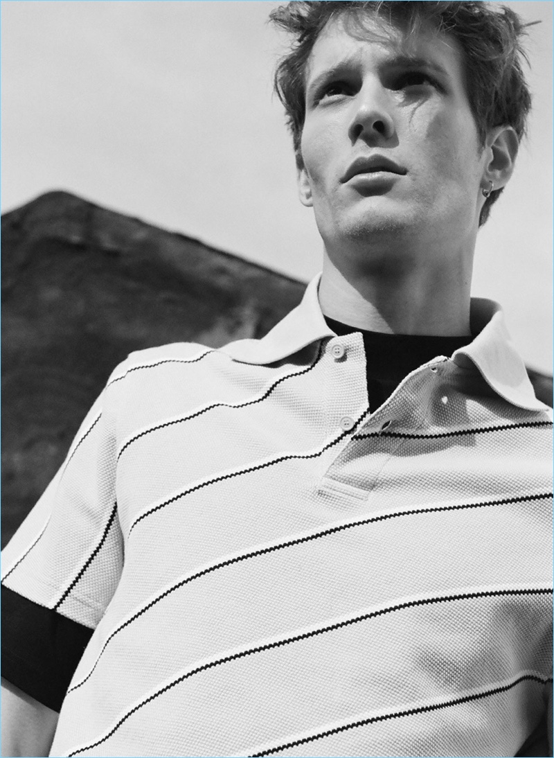French model Felix Gesnouin wears an Acne Studios tee $175 and a Balenciaga striped polo $281.