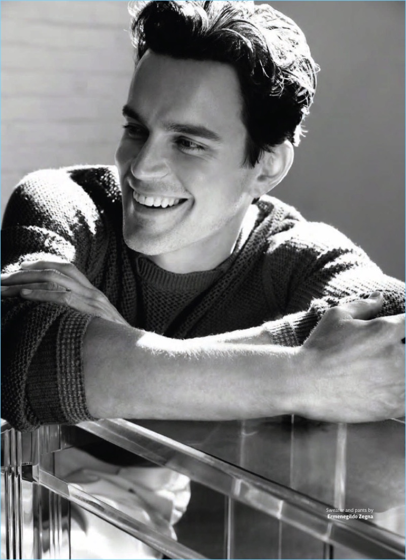 All smiles, Matt Bomer wears a sweater and pants by Ermenegildo Zegna.