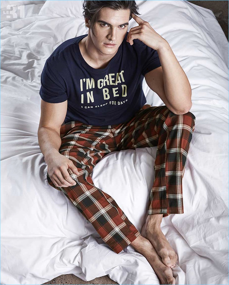 Taking it easy, Matthew Terry sports pajama pants and a cheeky t-shirt from LE 31.